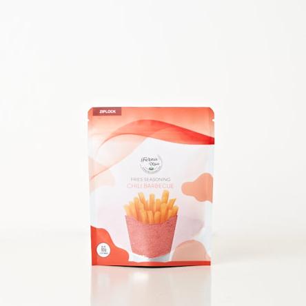 80 grams stand-up pouch packaging with zip lock of FERNA USA Fries Seasoning Chili Barbecue Flavor. The front displays an illustration of french fries and a transparent part of the packaging that makes the powder seasoning visible for the customer to see.
